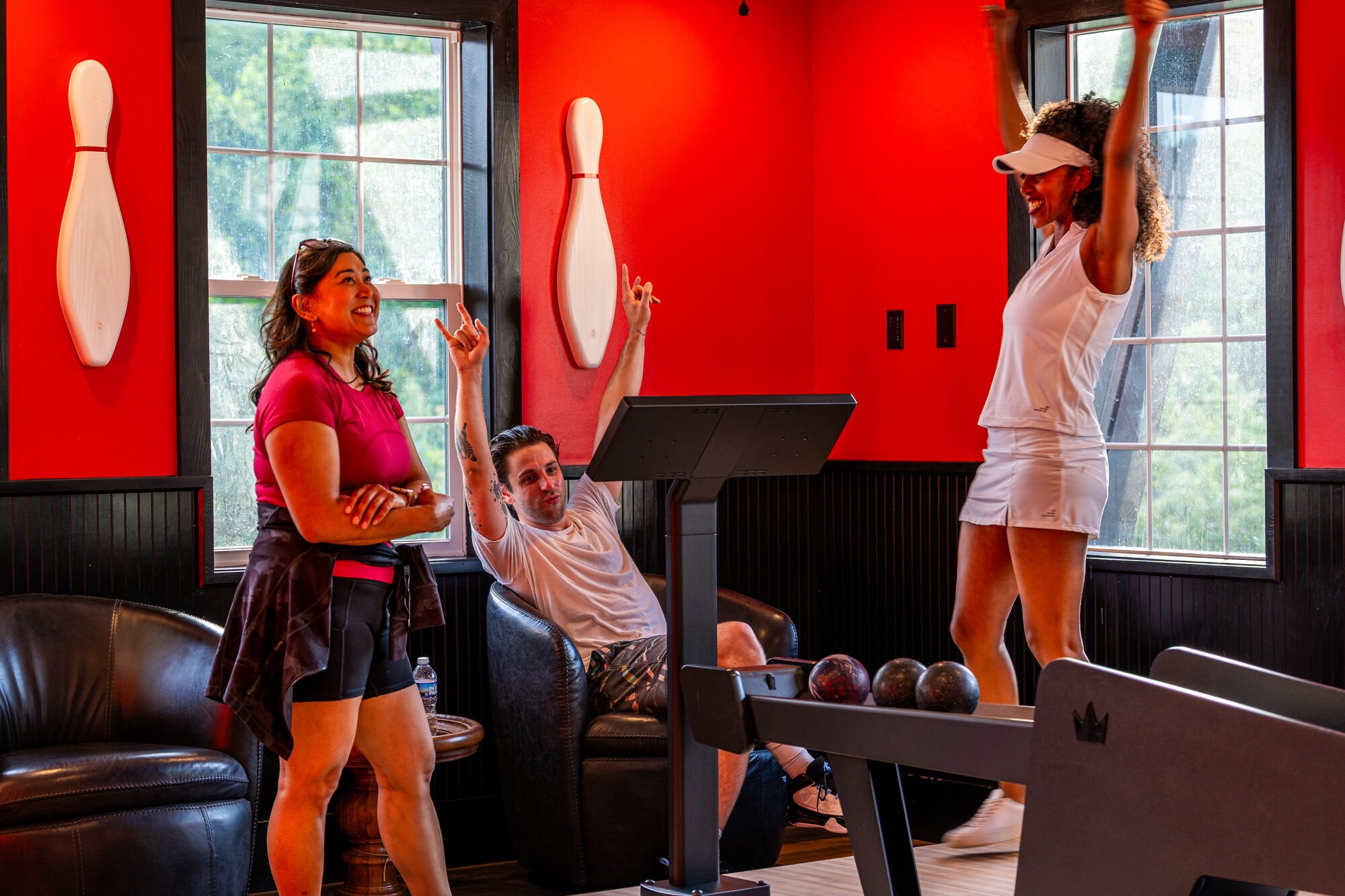 Guests celebrating a strike at Excalibur's private duckpin bowling alley