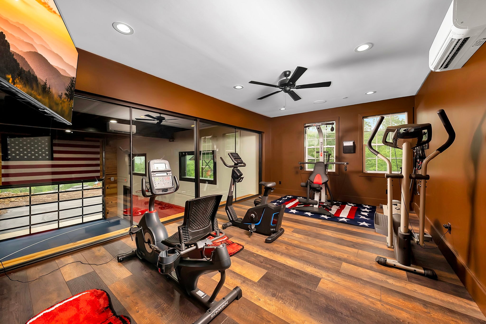 Excalibur indoor gym with cardio equipment and mirrors overlooking basketball court