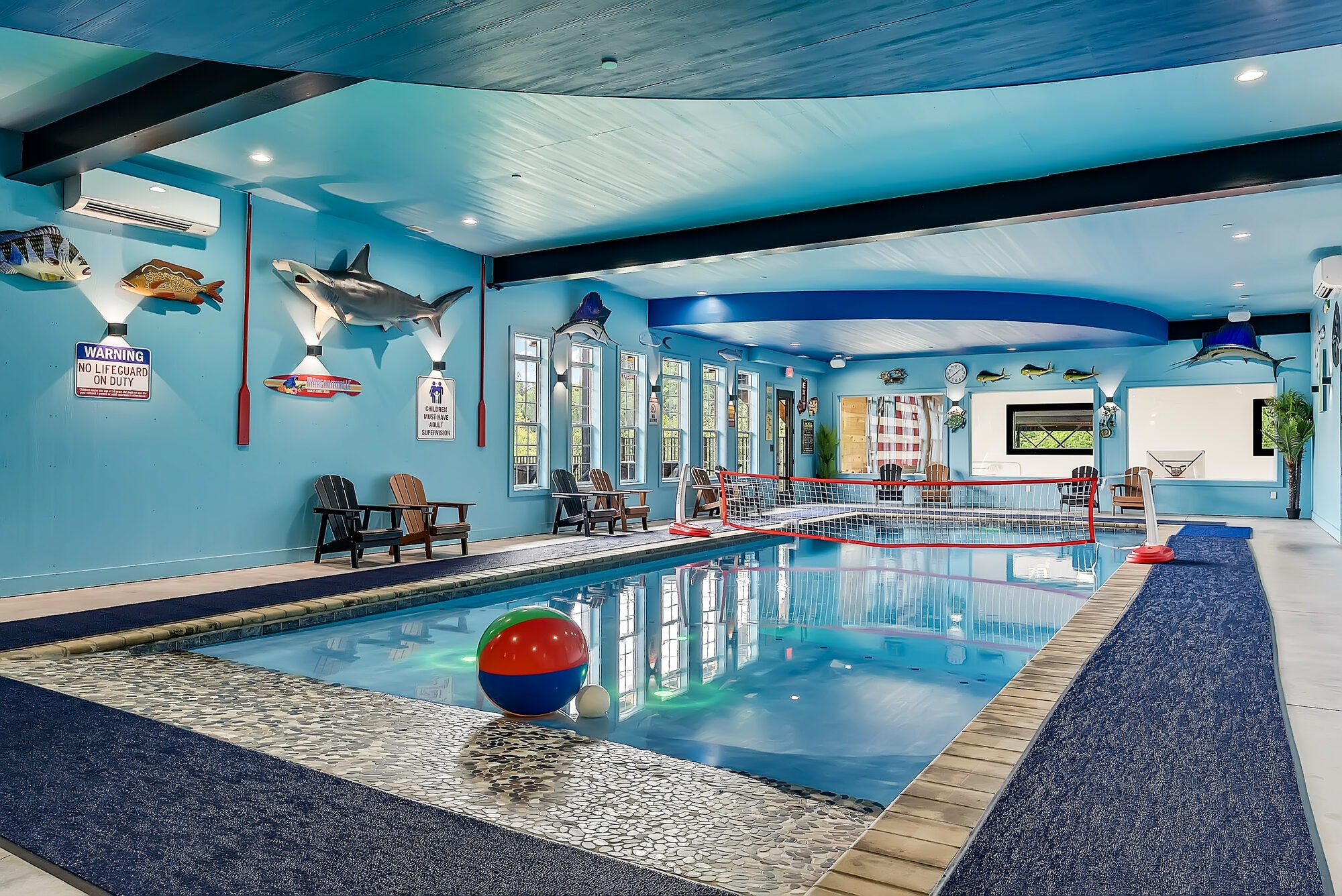 Excalibur indoor pool pebble beach entry beach ball red Adirondack lounge towel station