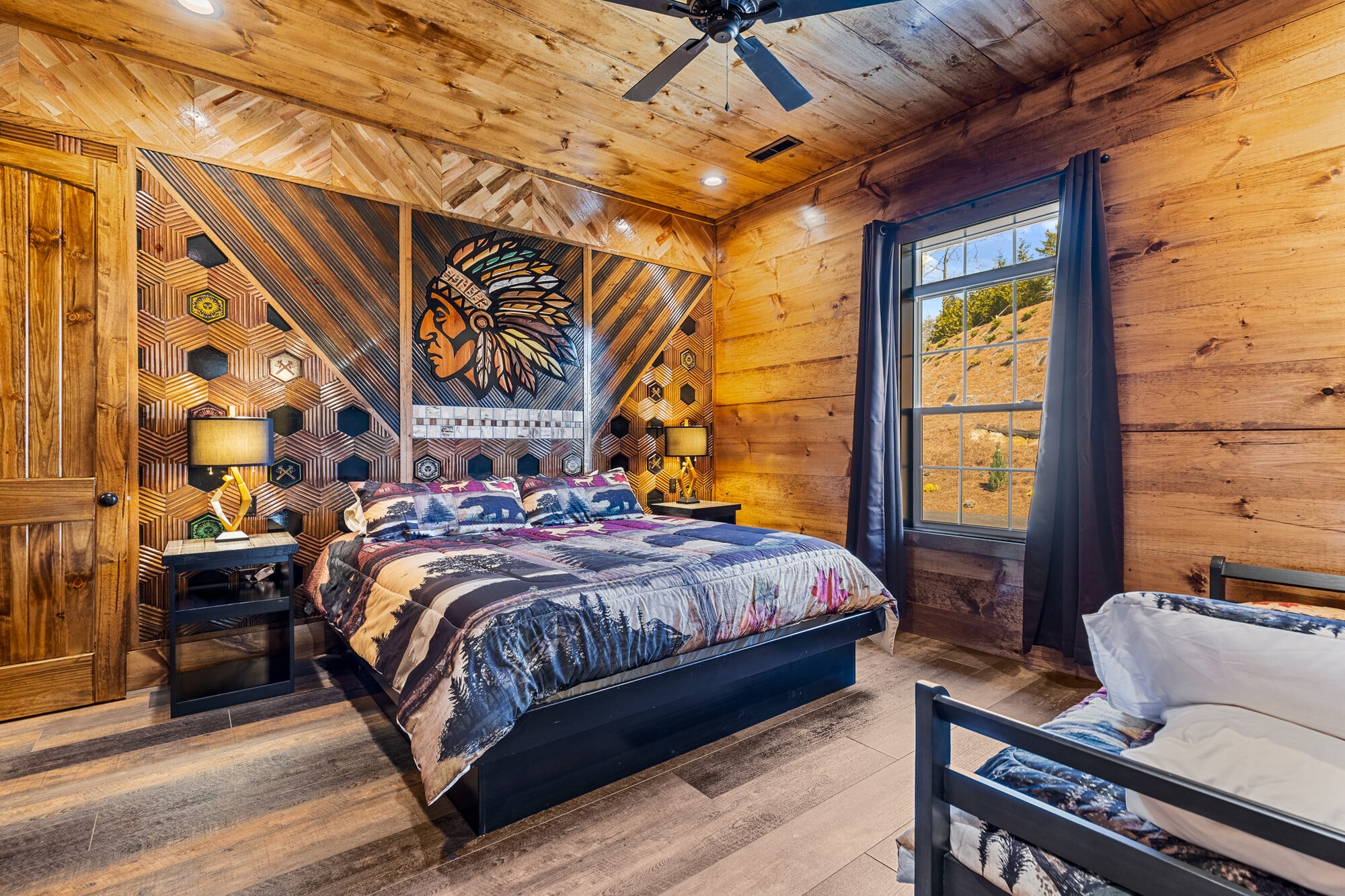 Rustic log cabin bedroom with native american art, upper level king suite