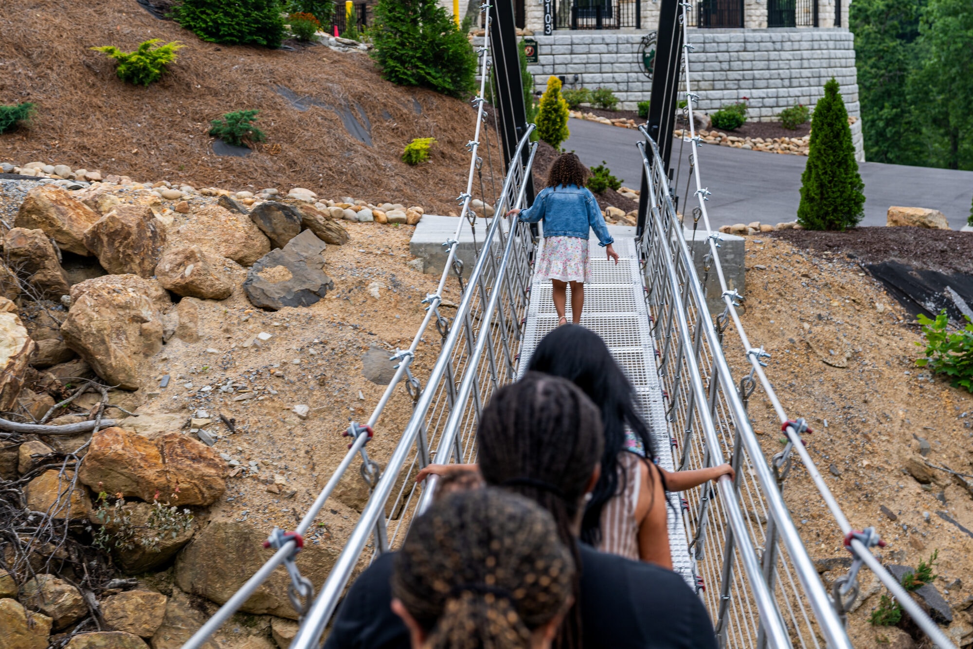 View down the length of Excalibur's private swinging bridge toward the Summit Nature Trail