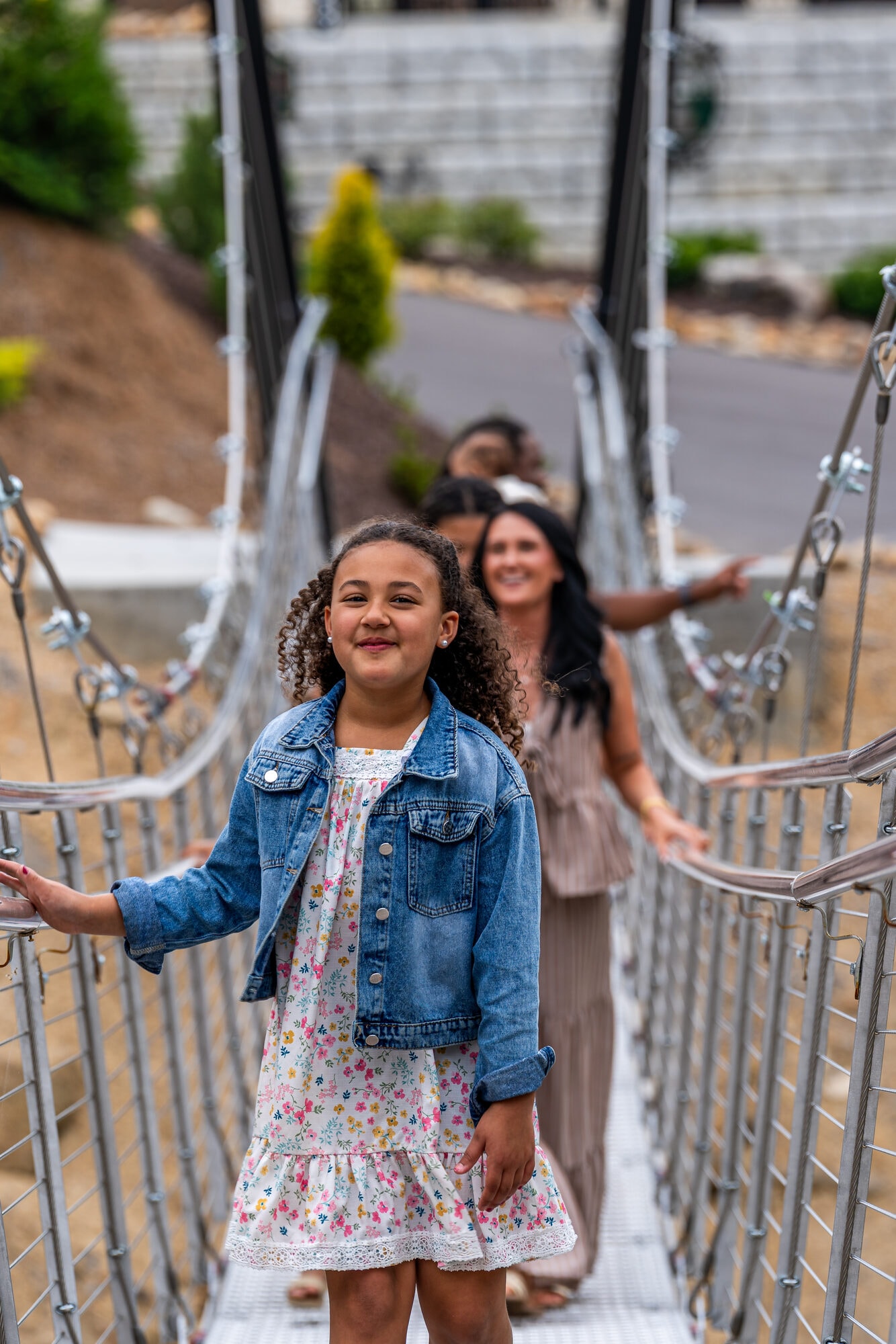 Young guest smiling on the private swinging bridge at Excalibur lodge, Smoky Mountains