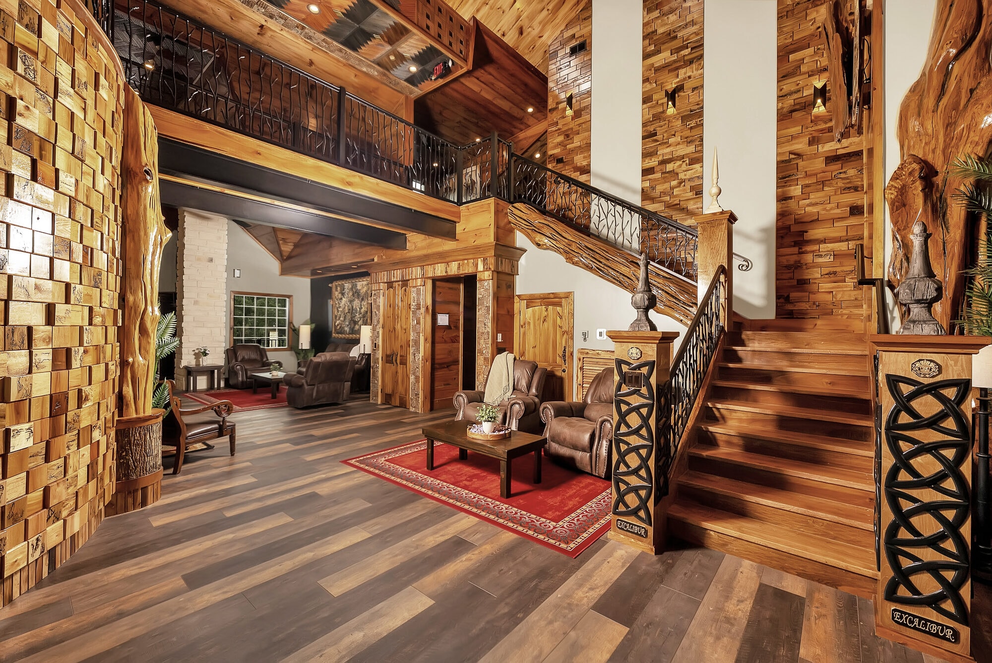 Custom Celtic knotwork staircase with hand-carved Excalibur newel posts and wrought iron branch railings in the grand entry hall